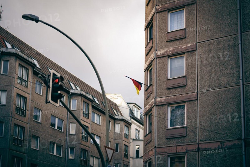A German flag hangs from a residential building near Hackescher Markt in Berlin