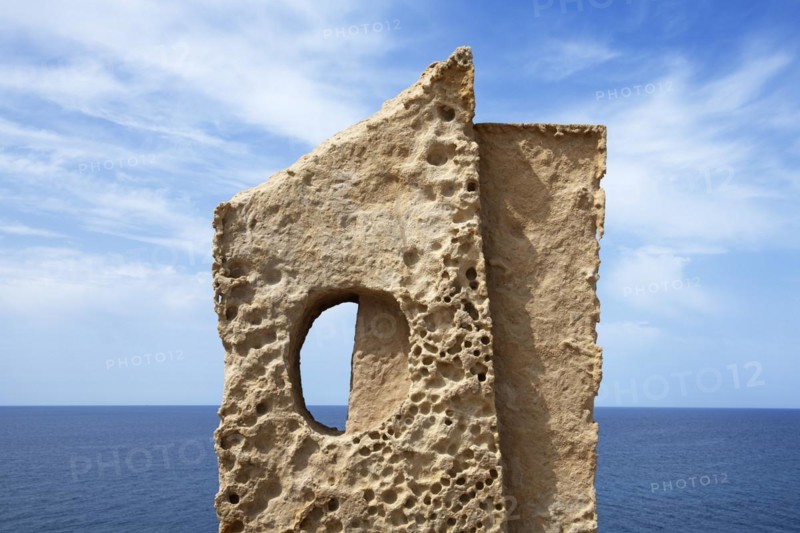 Stone sculpture in front of the coast