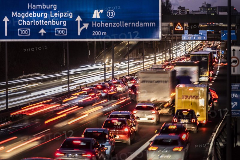 Congested traffic on the A100 looms at blue hour in Berlin
