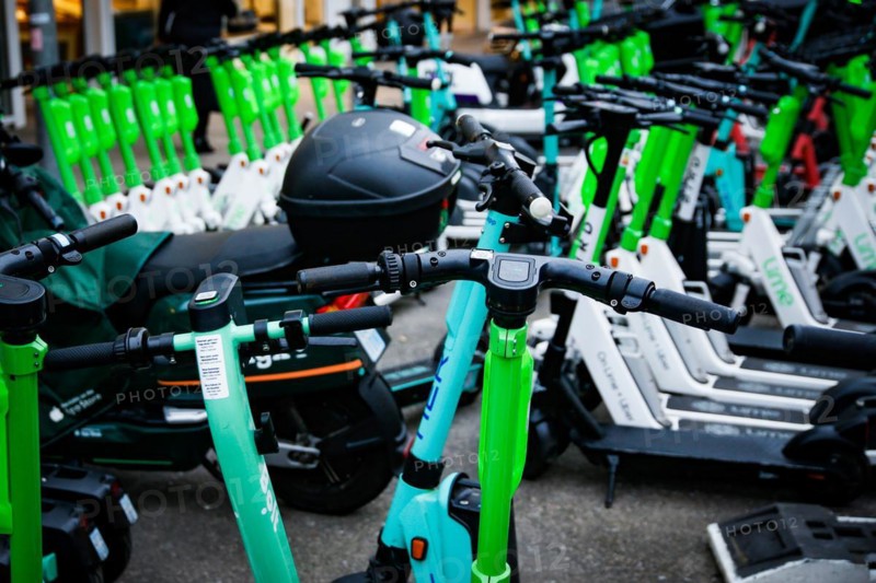 E-scooters of various providers standing on a designated parking space for sharing providers in Duesseldorf