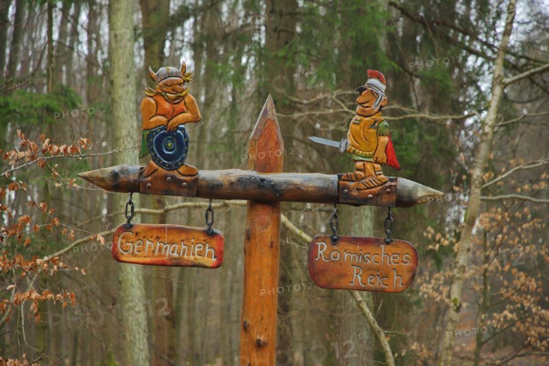 Historical Limes Boundary with signpost by wooden figures