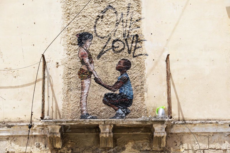 Mural One Love on weathered facade