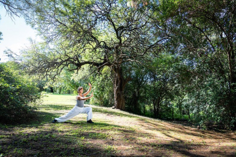 A woman practices Tai Chi in parks. Practicing outdoors provides a calm and relaxing environment for meditation and concentration