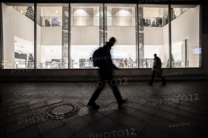 People stand out against Christmas decorations in a shopping centre on Schlossstrasse in Berlin