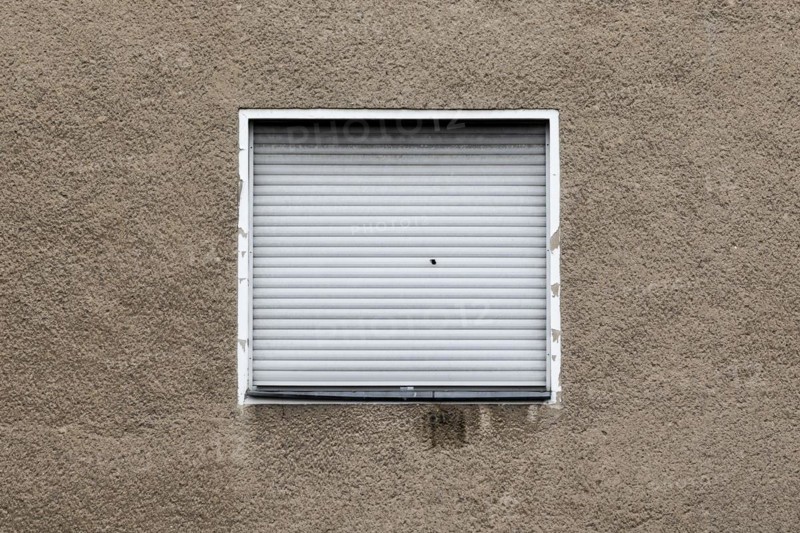 Lowered blinds stand out at an abandoned residential building in Berlin