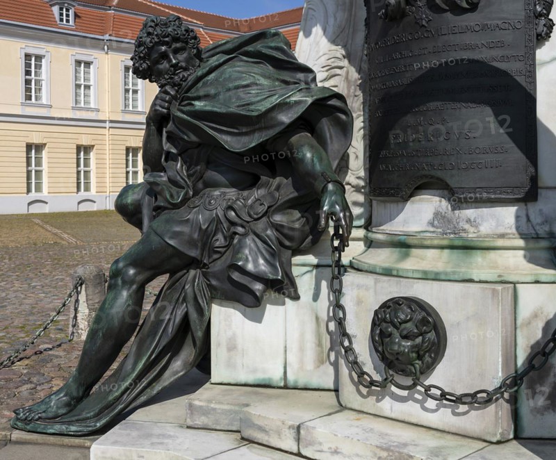 Detail photo of the chained warriors at the base of the equestrian statue of Frederick William of Brandenburg