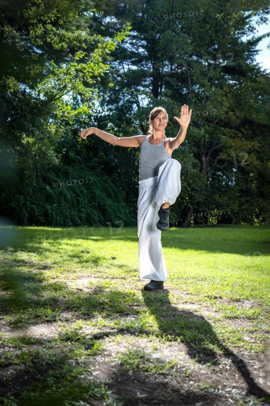 Kung Fu student woman practicing the activity for holding balance