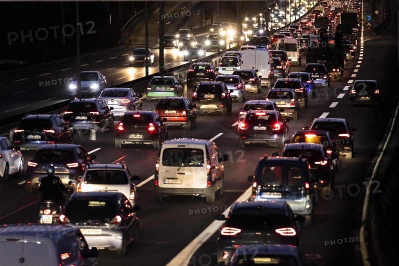 Congested traffic on the A100 looms at blue hour in Berlin