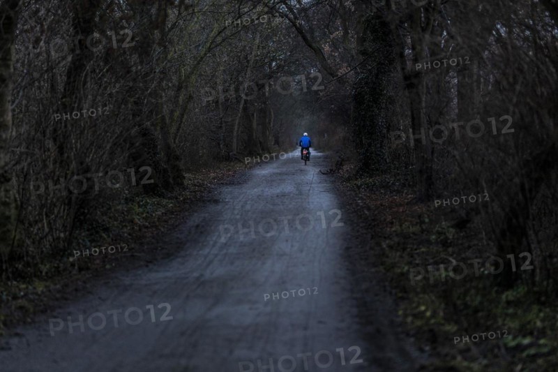 A man rides his bicycle along the Teltow Canal in Berlin
