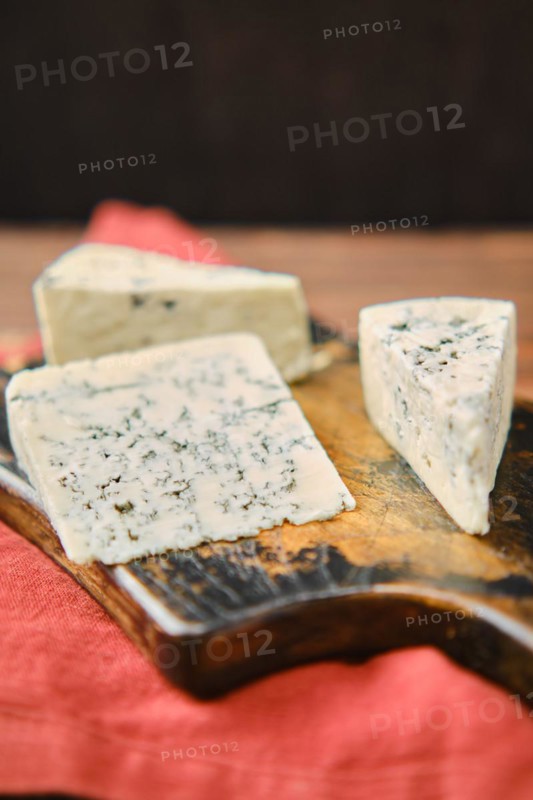 Closeup photo with shallow depth of field of different types of blue cheese