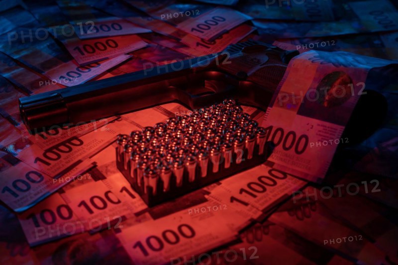 Elegant Semiautomatic 9mm Handgun with Swiss Helvetia Symbol Leaning on Swiss Franc 1000 Banknote and Bullet Ammunition in Switzerland