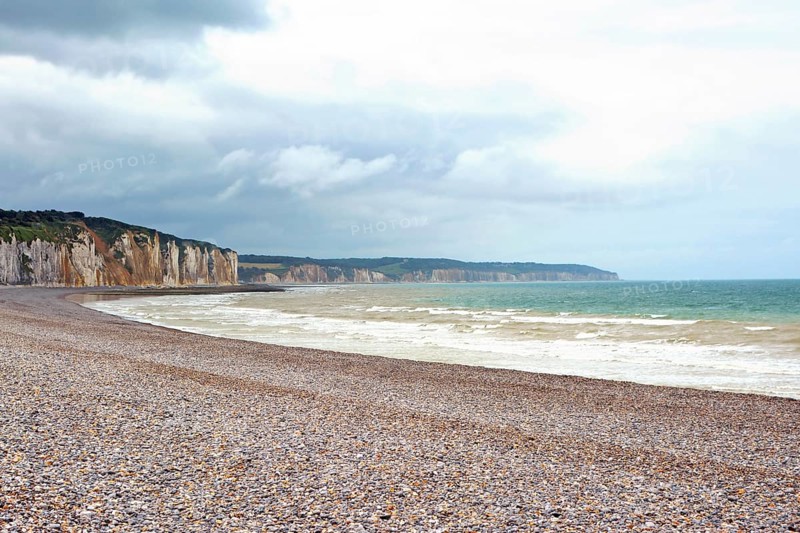 Scenery landscape view of pebble beach and cliffs in background in Dieppe in Seine Maritime department in the Normandy region of northern France