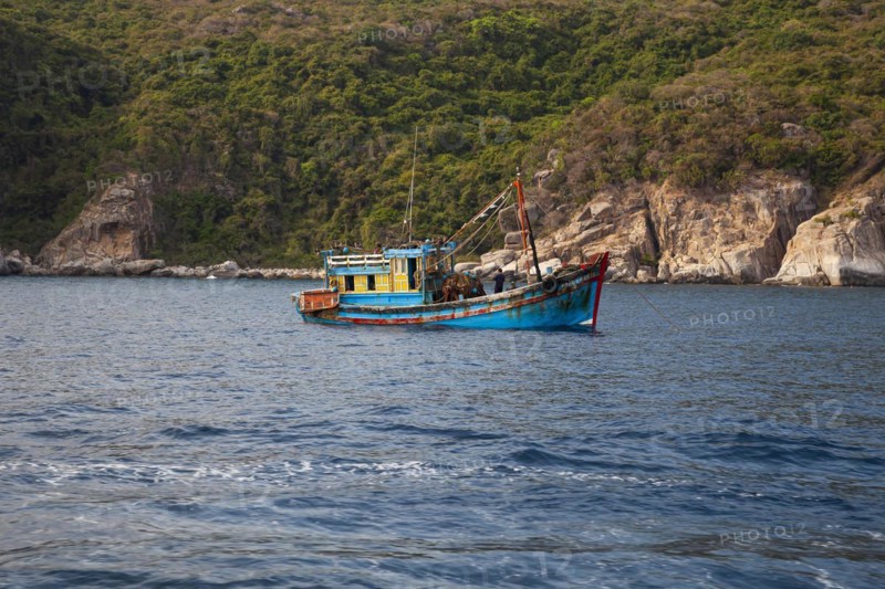 Fishing boat at Rocky coastal landscape