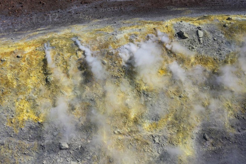 Smoking sulphur fumaroles at the crater rim