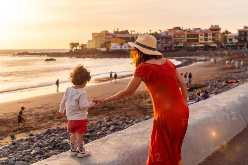 Mother and son at sunset on vacation on the beach of Valle Gran Rey village on La Gomera