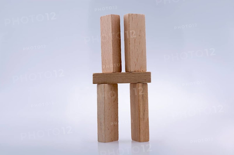 Wooden domino pieces positioned on white background