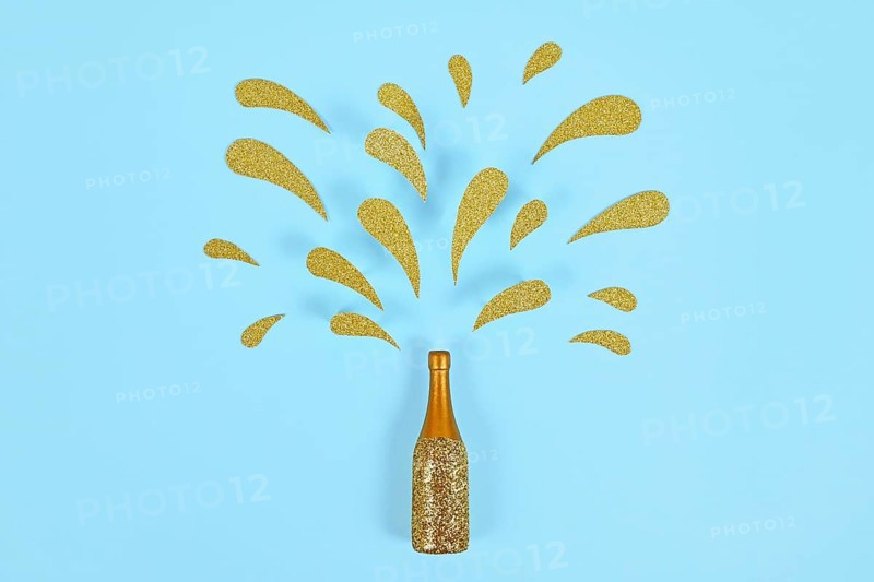 Golden splashing Champagne bottle on blue background
