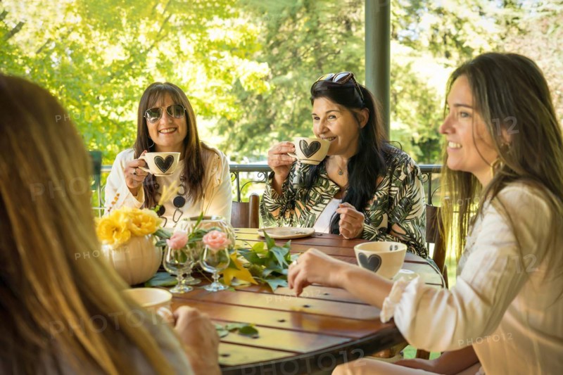 Group of happy friends sitting at a round table