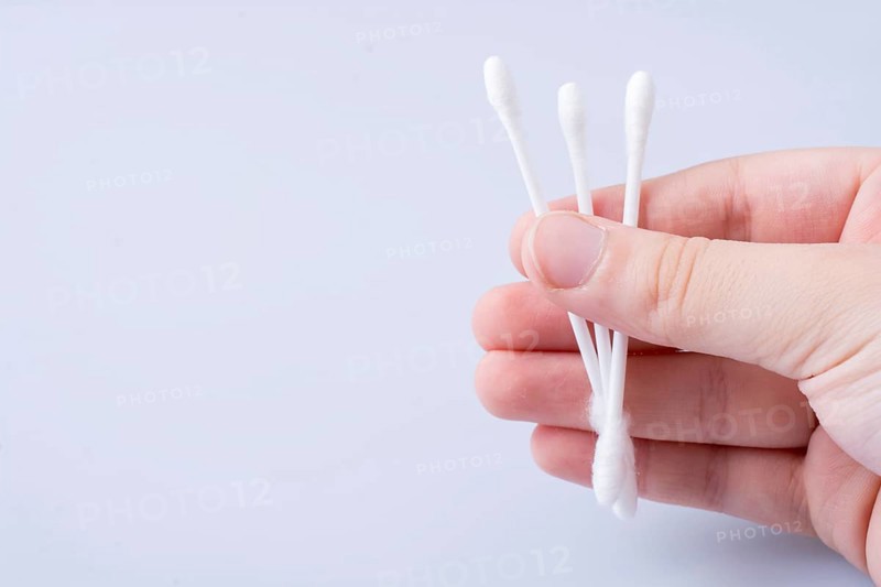 A few ear sticks in hand isolated on white background