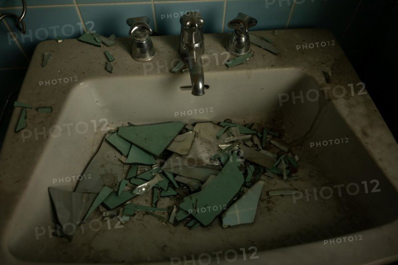 Abandoned House in Bathroom with Broken Mirror in Sink in Switzerland