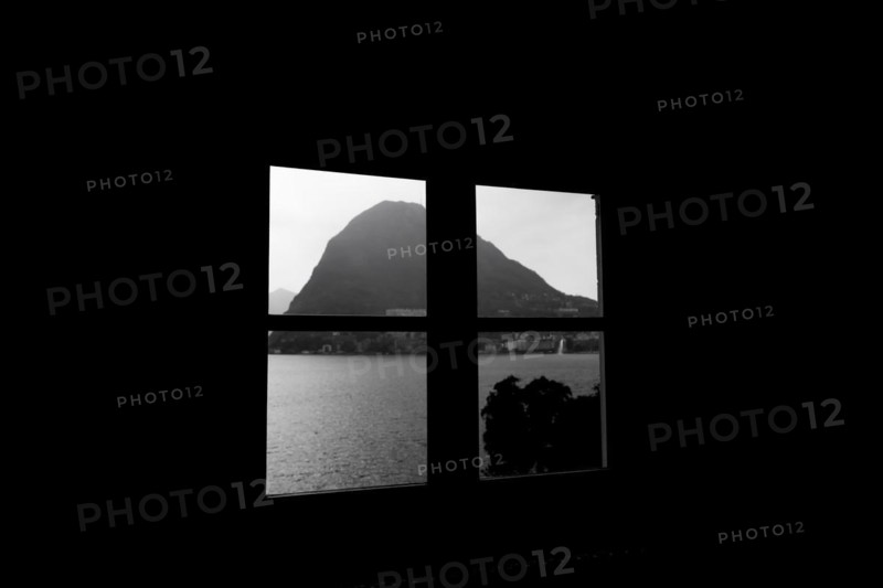 Window View over Lake Lugano with Mountain Peak Monte Bre and Sunlight in Lugano