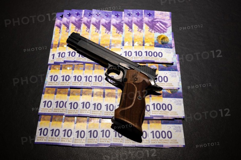 Elegant Semiautomatic 9mm Handgun with Swiss Helvetia Symbol Leaning on Swiss Franc 1000 Banknote in Switzerland