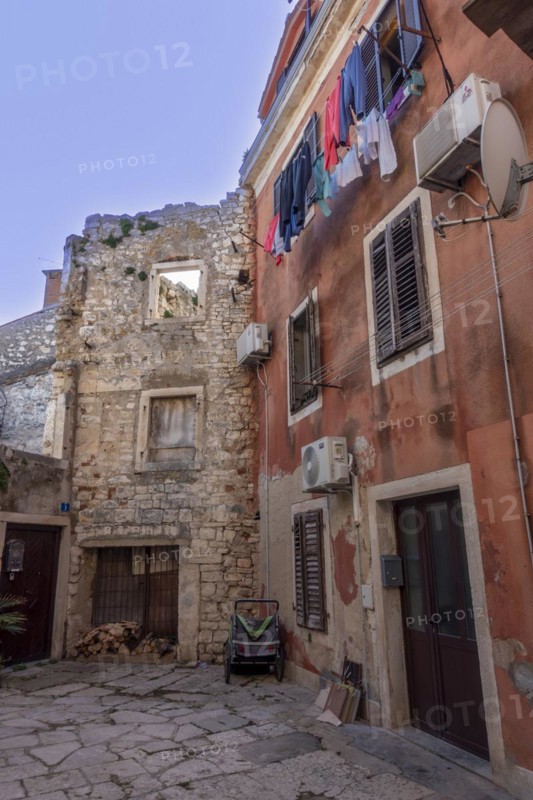Laundry is hung out to dry on a line on an old house in an alleyway in the coastal town of Umag