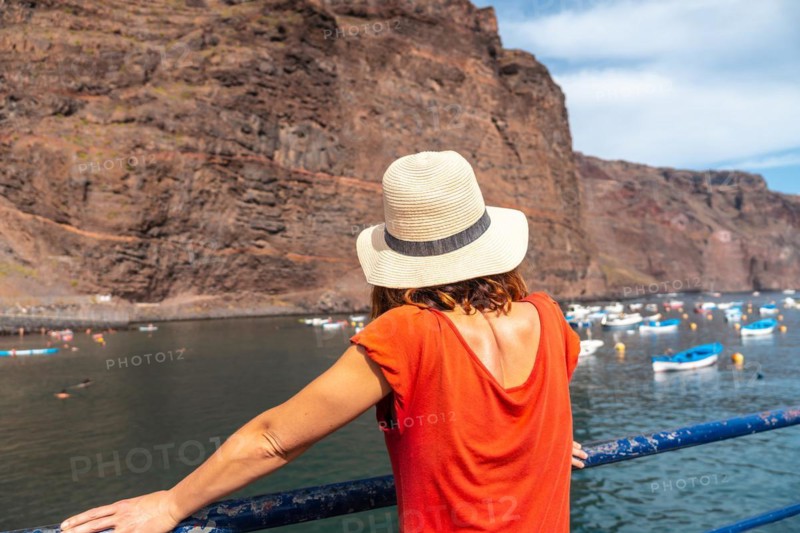 A woman looking at the beach from the fishing port of Valle Gran Rey village on La Gomera