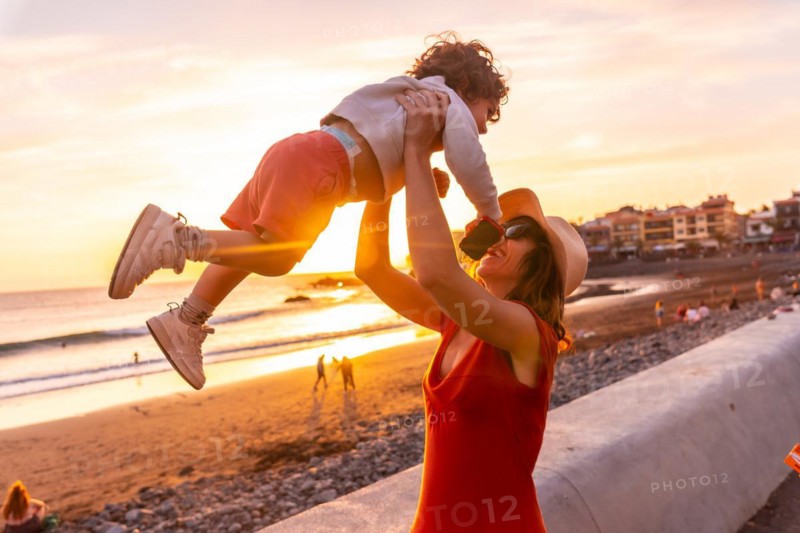 Mother and son at sunset on the beach of Valle Gran Rey in La Gomera