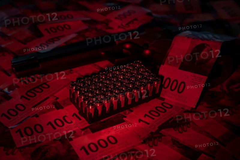 Elegant Semiautomatic 9mm Handgun Leaning on Swiss Franc 1000 Banknote and Bullet Ammunition in Switzerland