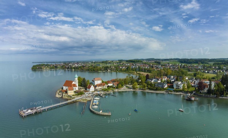 Aerial panorama of the moated castle peninsula on Lake Constance with the baroque church of St. George