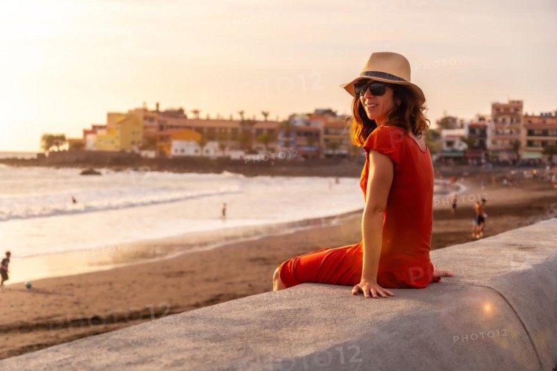 Tourist woman at sunset on vacation on the beach of Valle Gran Rey village on La Gomera