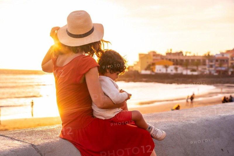Mother and son at sunset on the beach of Valle Gran Rey village in La Gomera