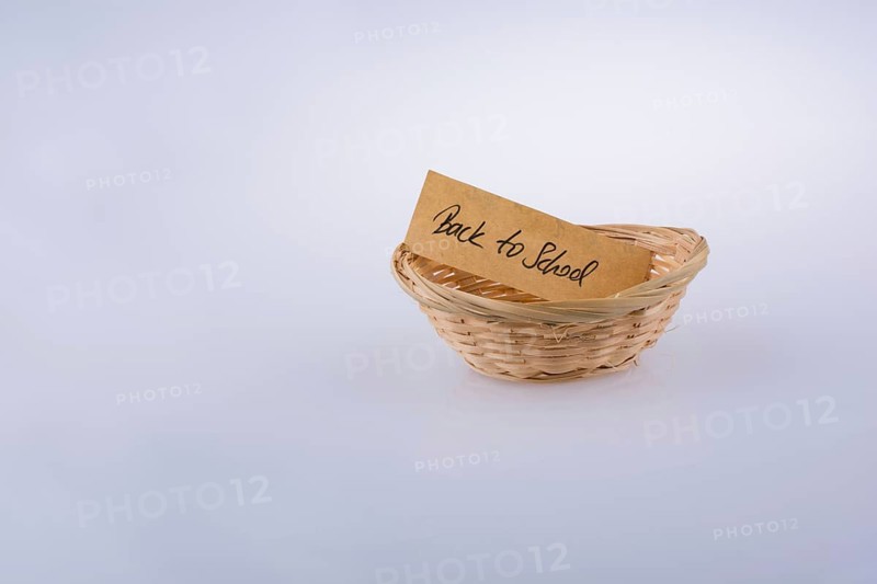 Back to school written on a note paper in a wooden basket