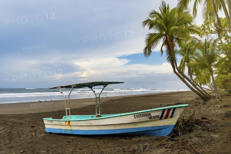 Fishing boat on a lonely beach in Costa Rica. Tropical weather