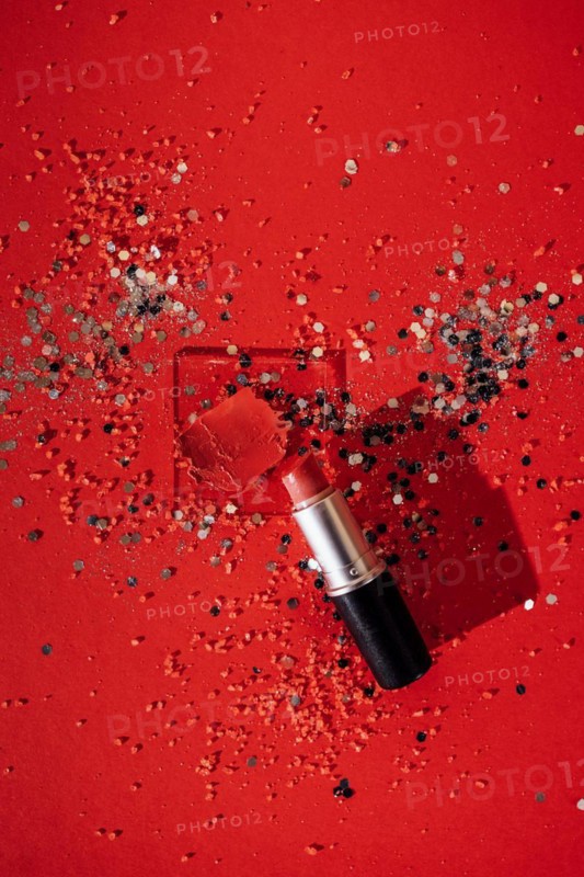 Cosmetics smear of smudged red lipstick on transperent glass