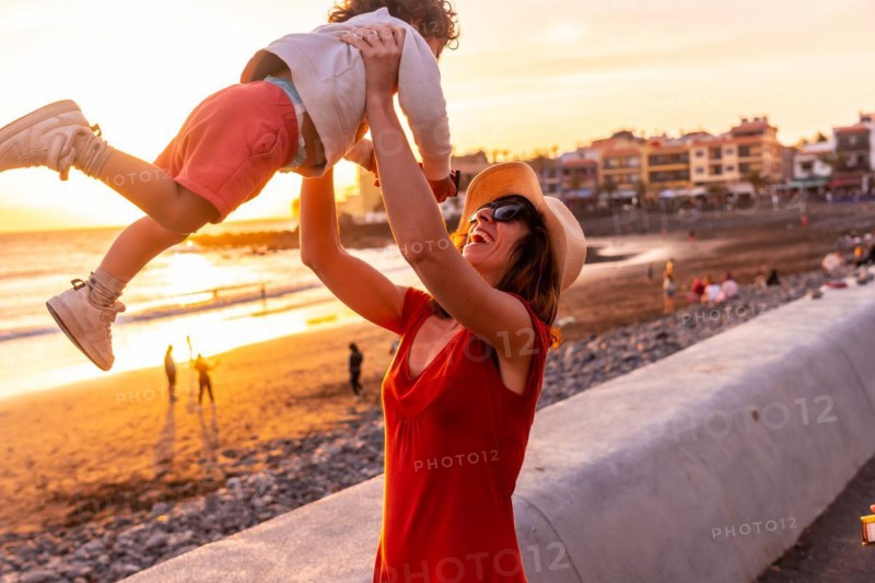 Mother and son at sunset on the beach of Valle Gran Rey in La Gomera