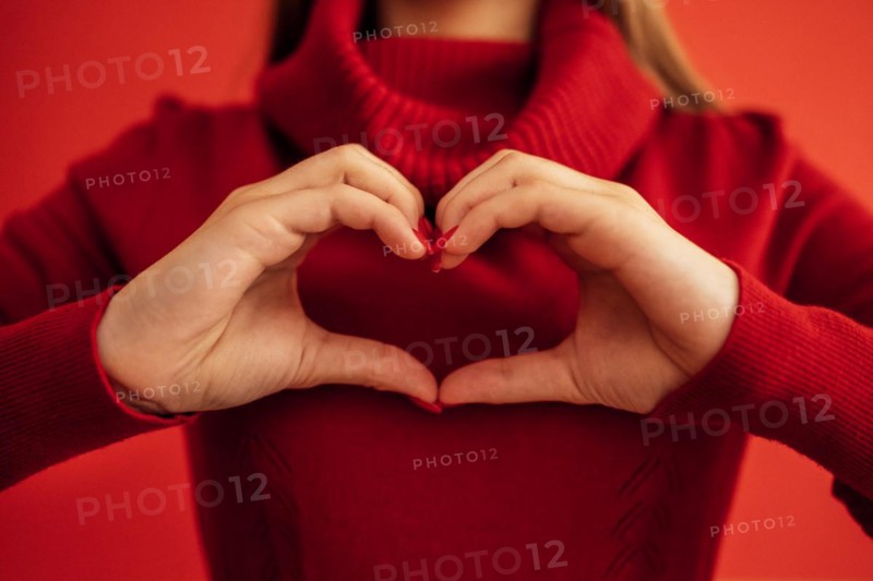 Female hands make a heart shape