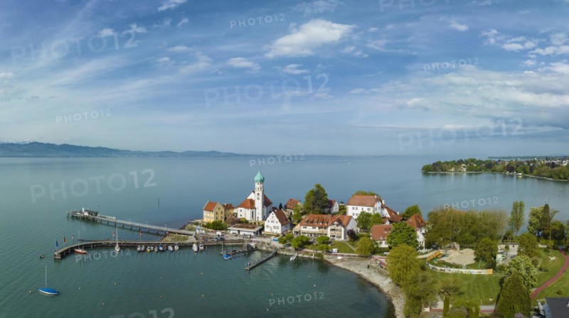 Aerial panorama of the moated castle peninsula on Lake Constance with the baroque church of St. George