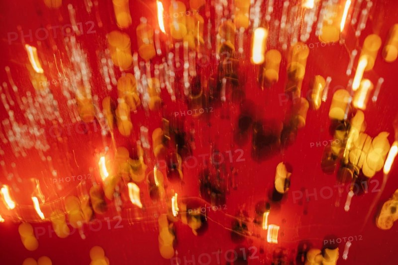 Red tone blurs the bokeh light. Defocused Red and orange holiday bokeh. Abstract christmas background
