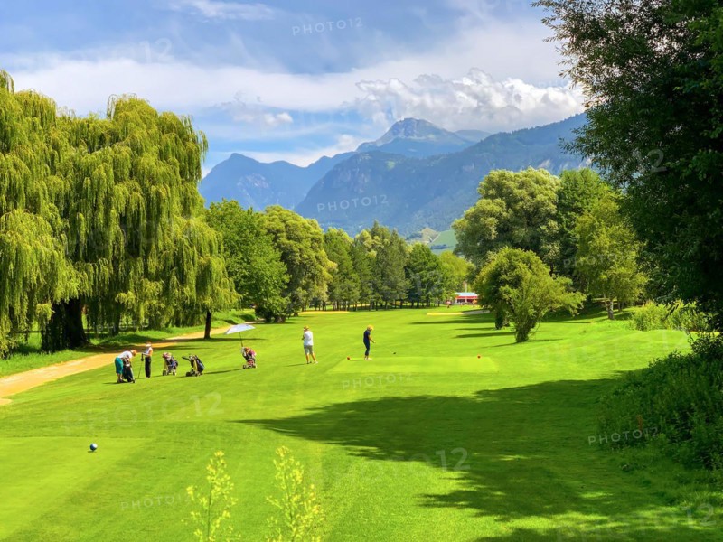 Golf Course Sierre Hole 18 with Mountain View and Clouds in a Sunny Summer Day in Granges
