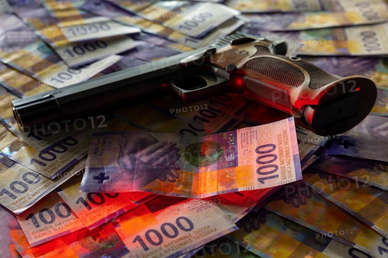 Elegant Semiautomatic 9mm Handgun with Swiss Helvetia Symbol Leaning on Swiss Franc 1000 Banknote in Switzerland