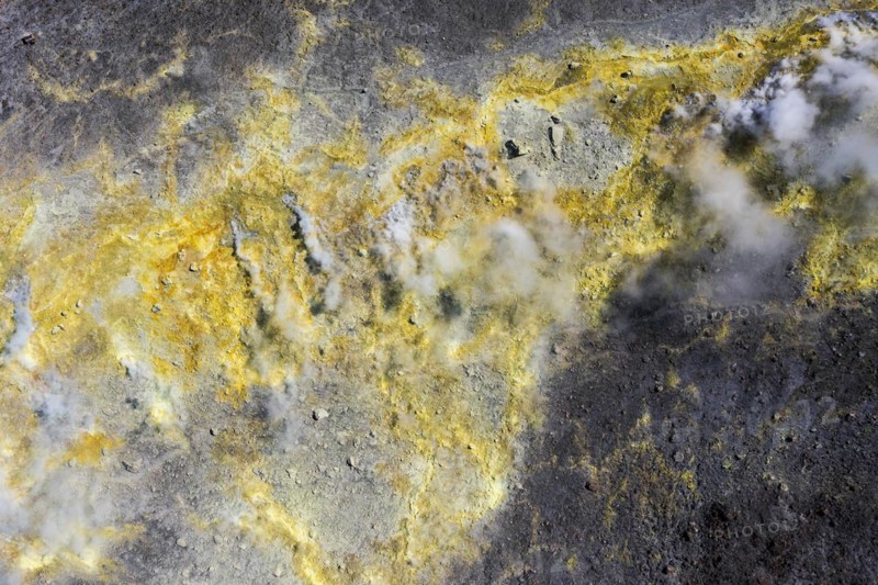 Smoking sulphur fumaroles at the crater rim