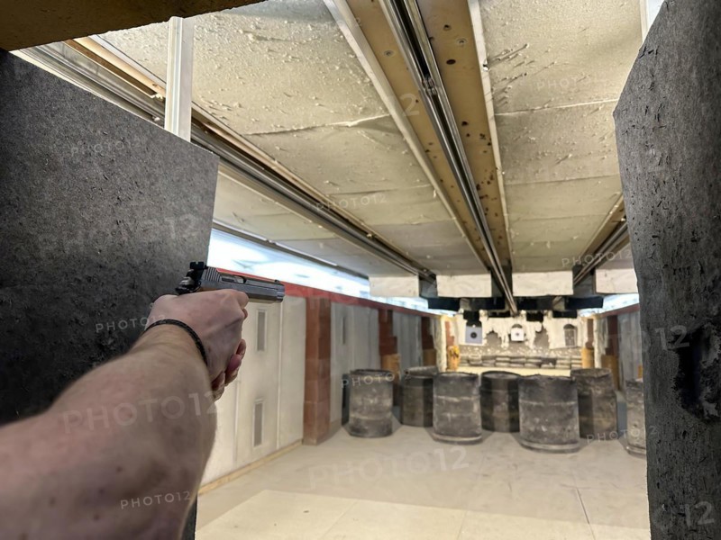 Man Shooting with a 9mm Handgun in Shooting Range in Switzerland