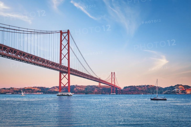 View of 25 de Abril Bridge famous tourist landmark over Tagus river