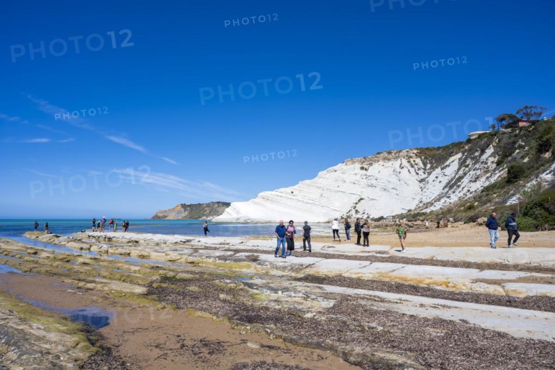 Tourists at the chalk cliff Scala dei Turchi