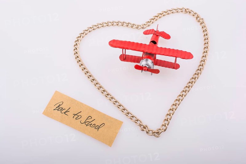 Chain forms a heart shape with a title back to school in it with a red model airplane