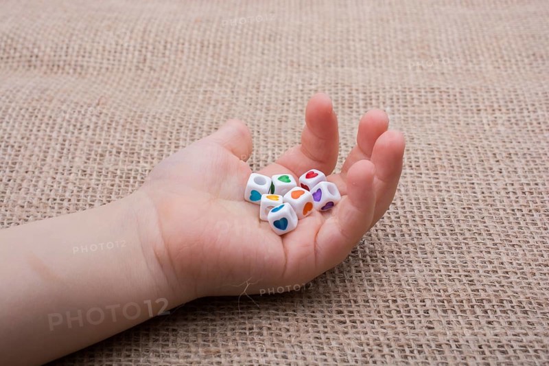 Colorful cubes with a heart in hand on canvas