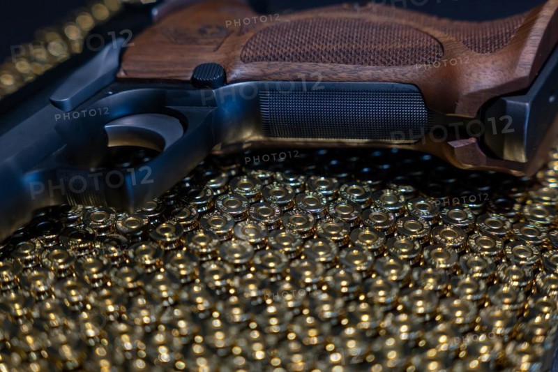 Elegant Semiautomatic 9mm Handgun with Swiss Helvetia Symbol Leaning on Bullet Ammunition in Switzerland