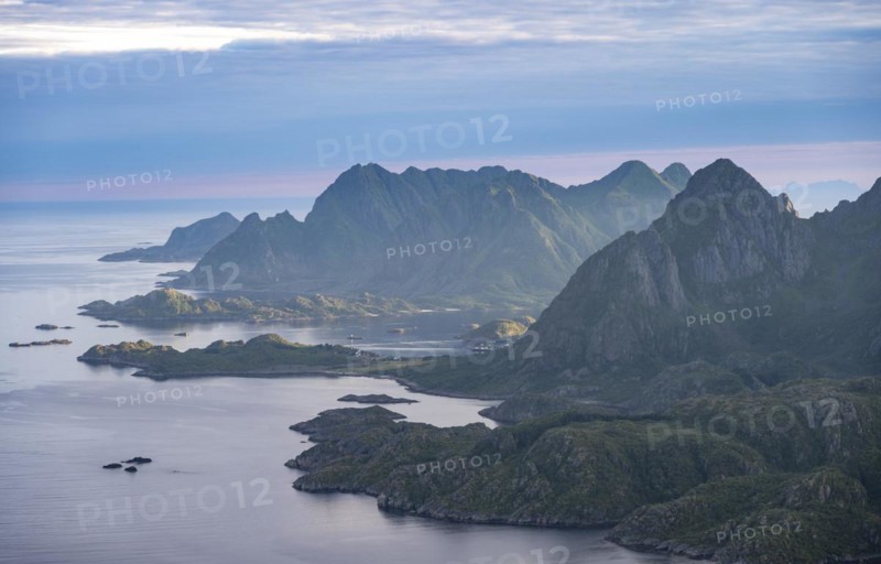 View of coast in Raftsund fjord and mountains in the evening light